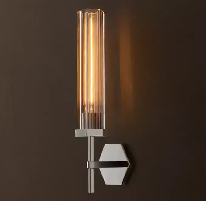 Elegant modern wall light with elongated glass tube and geometric base.