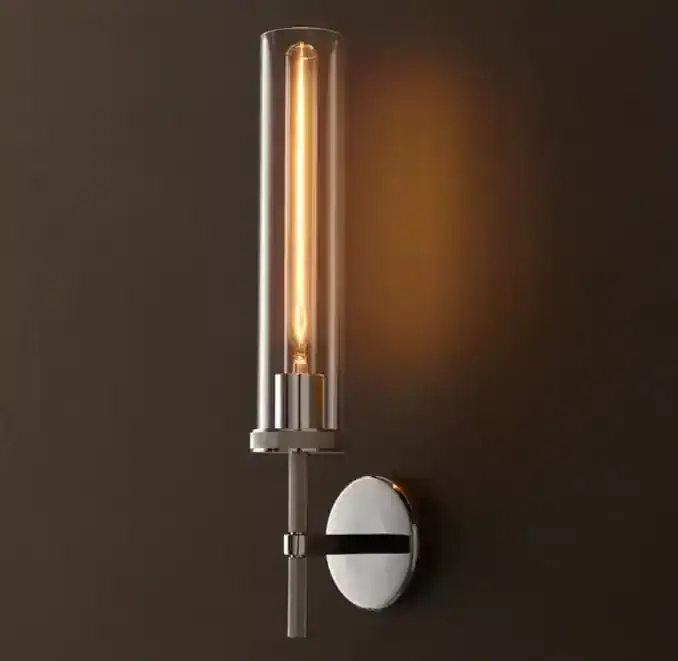 Modern wall lamp with exposed filament bulb for stylish lighting.