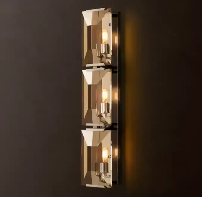 Contemporary wall sconce with three exposed filament bulbs for stylish lighting.