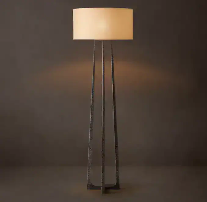 Modern floor lamp with beige lampshade and black metal tripod base.