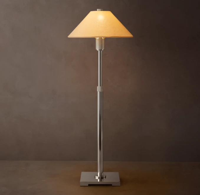 Elegant floor lamp with beige lampshade and chrome stand for modern decor.