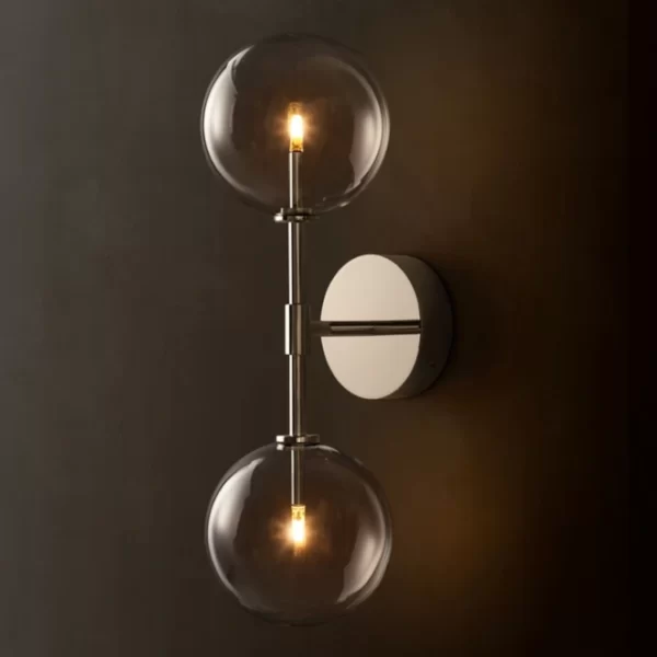 Contemporary wall lamp with glass globes and warm LED lighting.