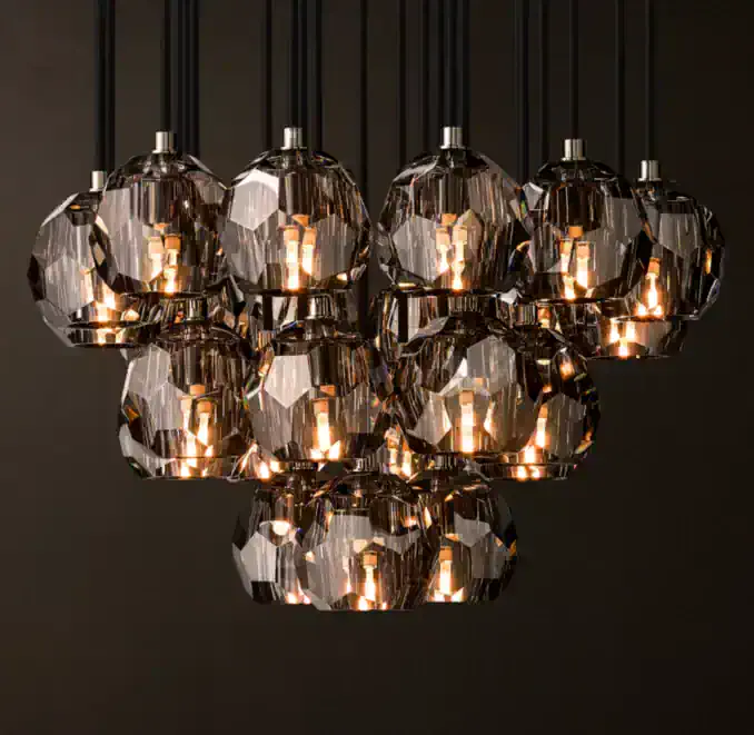Elegant modern crystal chandelier with multiple glass shades and warm lighting.