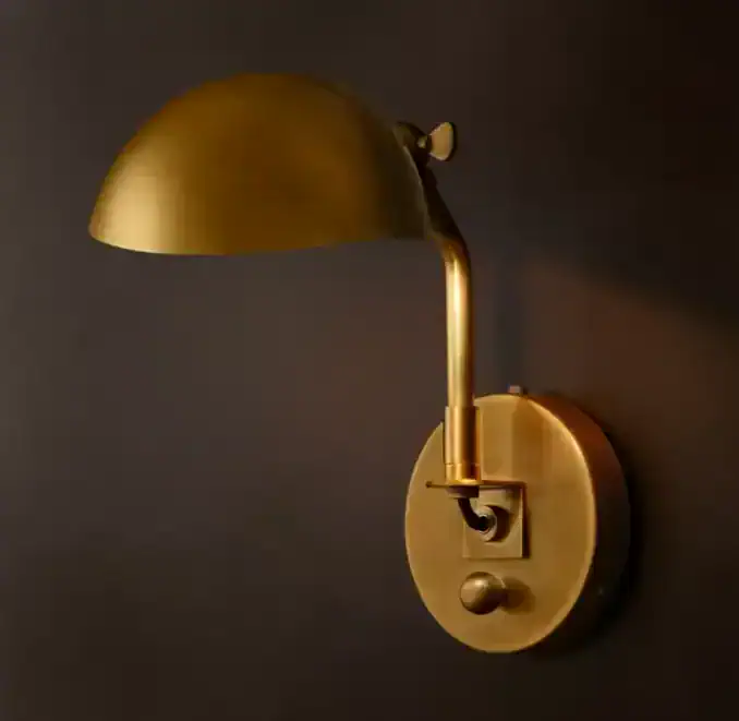 Elegant gold wall sconce with adjustable lamp for modern interior lighting.