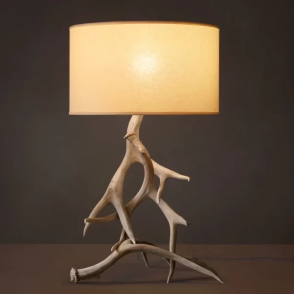 Unique lamp with driftwood base and beige lampshade for home decor.