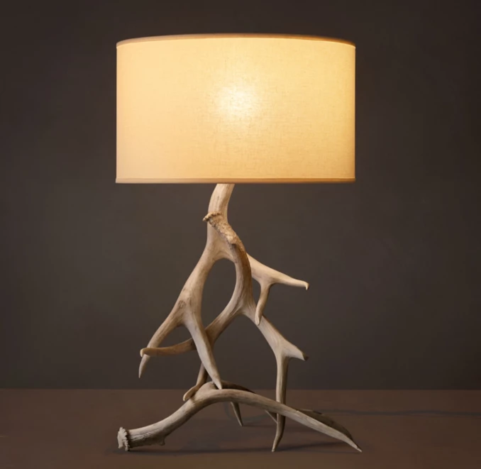 Unique lamp with driftwood base and beige lampshade for home decor.
