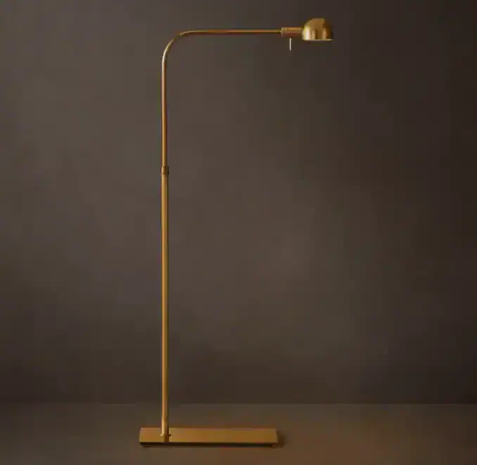 Elegant gold floor lamp with adjustable arm for modern interior lighting.