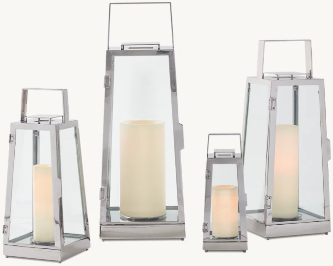 Set of modern lanterns with candles for outdoor or indoor decor.