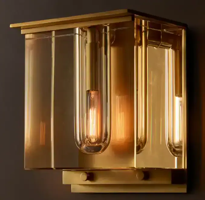 Elegant modern wall lamp with gold finish and glass tubes for stylish lighting.