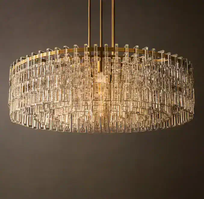 Elegant crystal chandelier by Gorvey Lighting with gold accents.