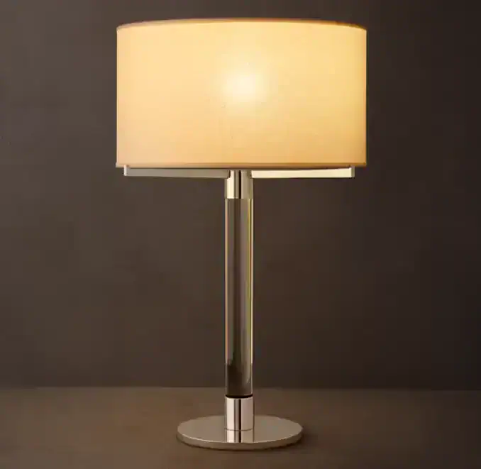 Elegant modern table lamp with a beige lampshade and metallic base.