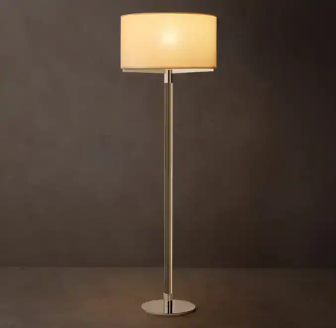 Modern floor lamp with a beige lampshade and sleek metal stand.