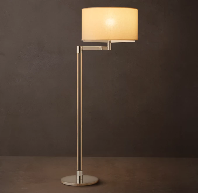Elegant modern floor lamp with a beige lampshade and sleek metallic stand.
