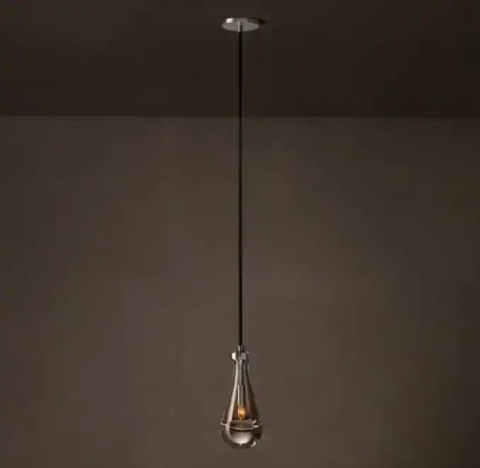Elegant modern pendant lamp hanging from ceiling with a glass teardrop design.