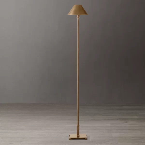 Elegant gold floor lamp with beige lampshade in modern interior.