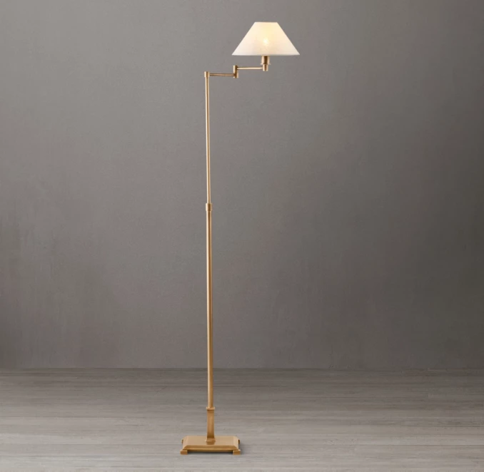 Elegant metal floor lamp with linen shade and adjustable swing arm.