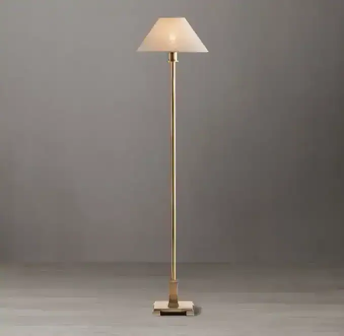 Elegant linen buffet lamp with a tall brass stand and white shade.
