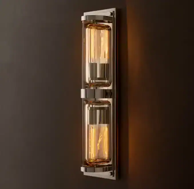 Modern wall sconce with glass and brass finish for ambient lighting.