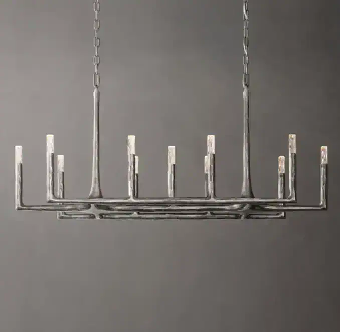 Modern metal linear chandelier with multiple candle-style lights.