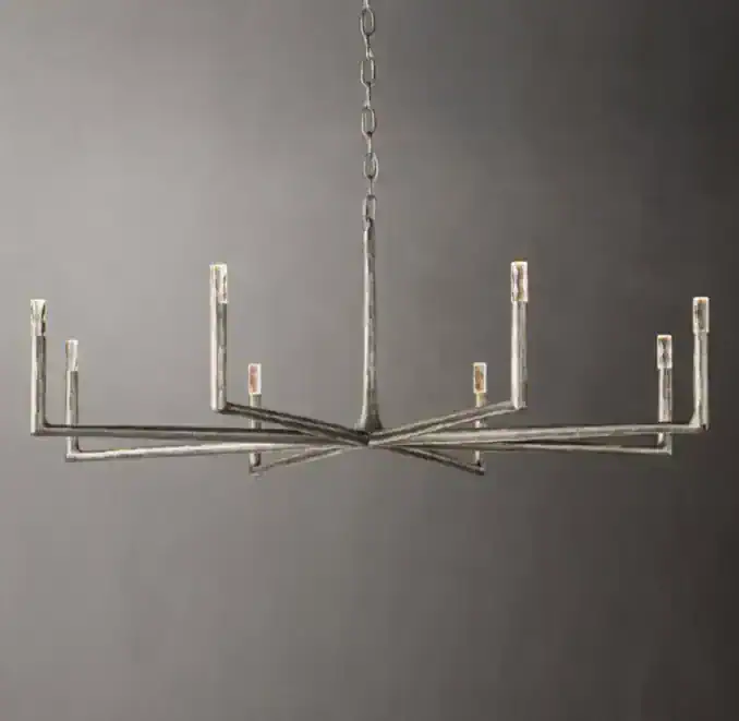 Modern forged metal chandelier with round design and multiple light fixtures.