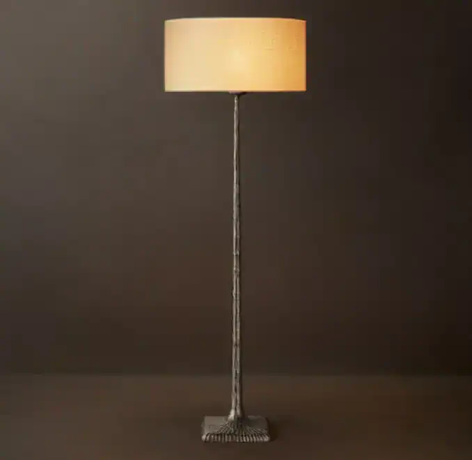 Modern metal floor lamp with linen drum shade for stylish lighting.