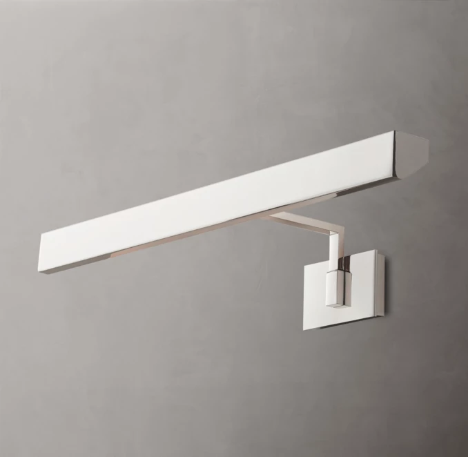 Modern brass picture light for wall decor and art illumination.