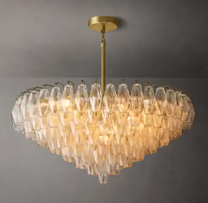Elegant tiered glass chandelier with gold fixture for modern interiors.