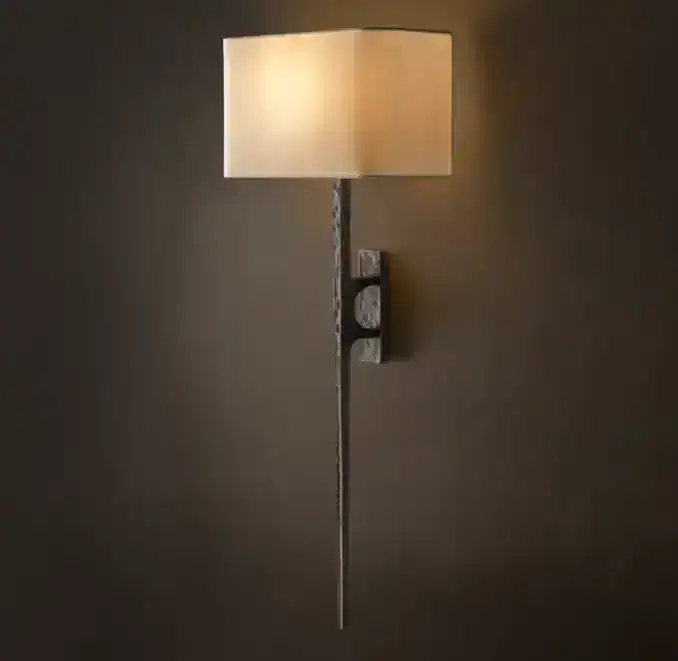 Modern wall-mounted lamp with beige shade and sleek design.