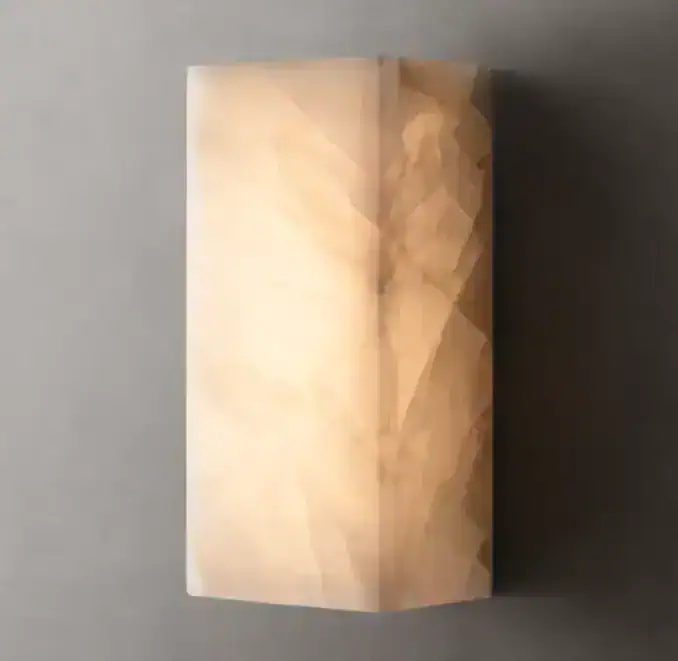 Modern wall sconce with a geometric, faceted design in neutral tones.