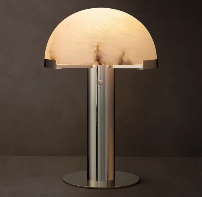 Modern table lamp with alabaster shade and brass base for elegant lighting.