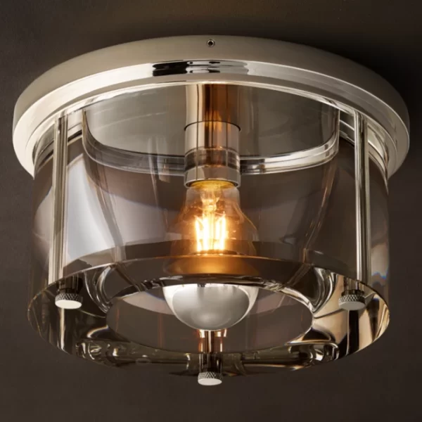 Modern round glass flushmount ceiling light with metallic accents.
