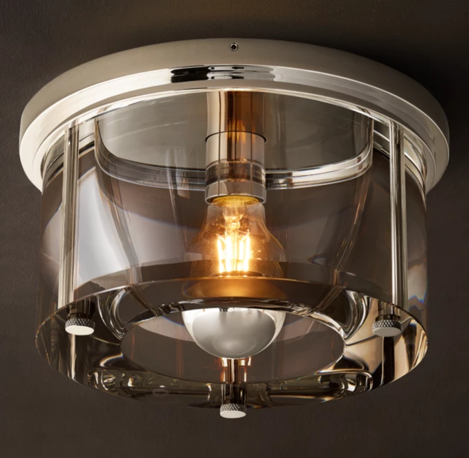 Modern round glass flushmount ceiling light with metallic accents.