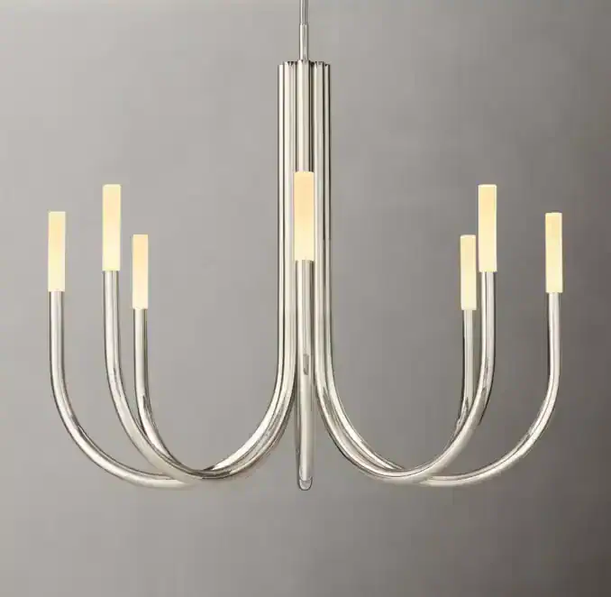 Modern brass LED chandelier with curved arms and candle-style lights.
