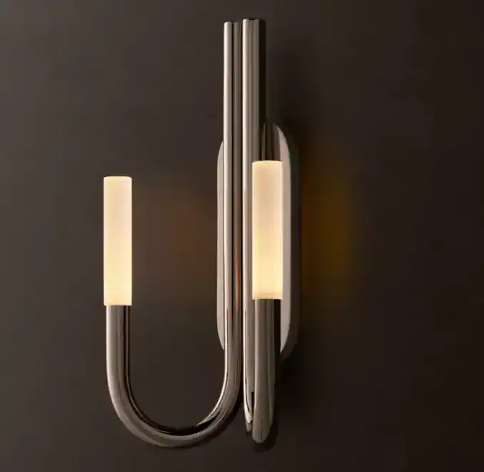 Modern brass and glass wall sconce with LED lighting for interior decor.