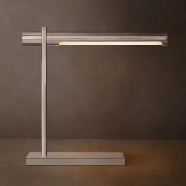 Modern brass table lamp with sleek design and adjustable arm.