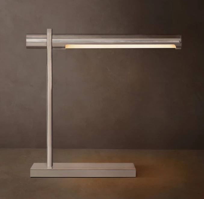 Modern brass table lamp with sleek design and adjustable arm.