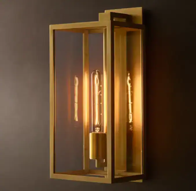 Modern wall lamp with exposed filament bulbs and gold frame design.
