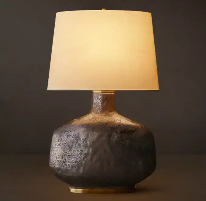 Modern ceramic table lamp with linen shade for stylish lighting.