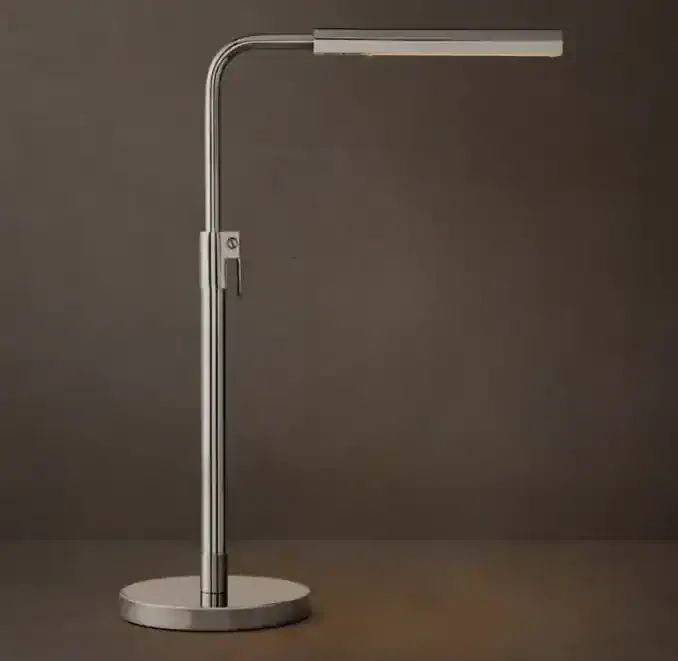Modern adjustable LED task lamp with sleek steel design for workspace.