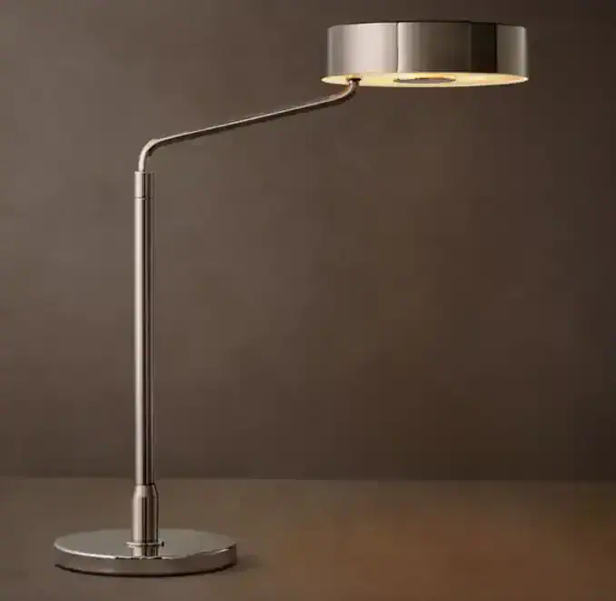 Modern brass task lamp with adjustable arm and sleek design.