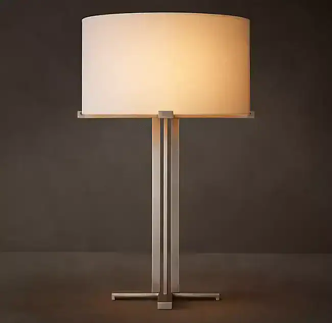 Modern brass floor lamp with a large fabric shade for elegant lighting.
