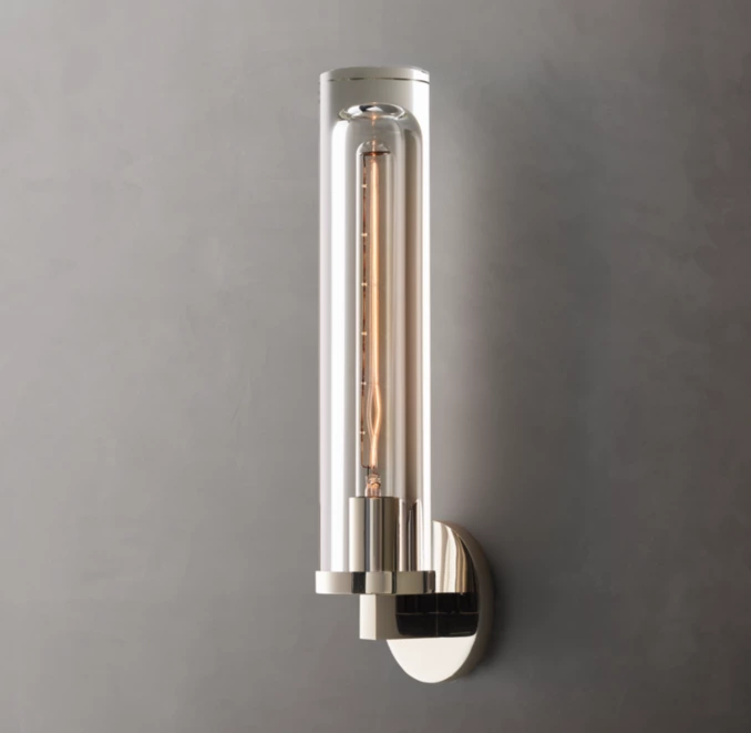 Modern wall sconce with glass and brass finish for elegant lighting.