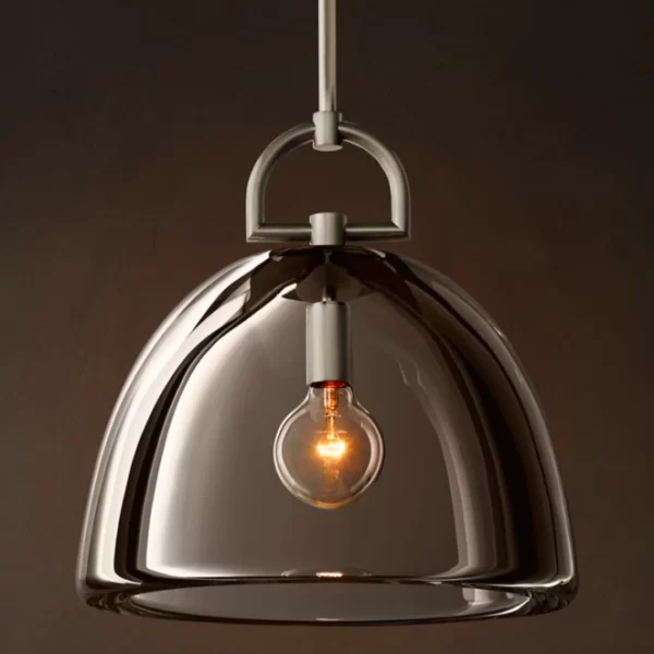 Modern pendant lamp with glass dome and brass details for stylish lighting.