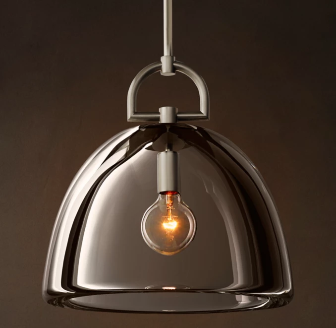Modern pendant lamp with glass dome and brass details for stylish lighting.