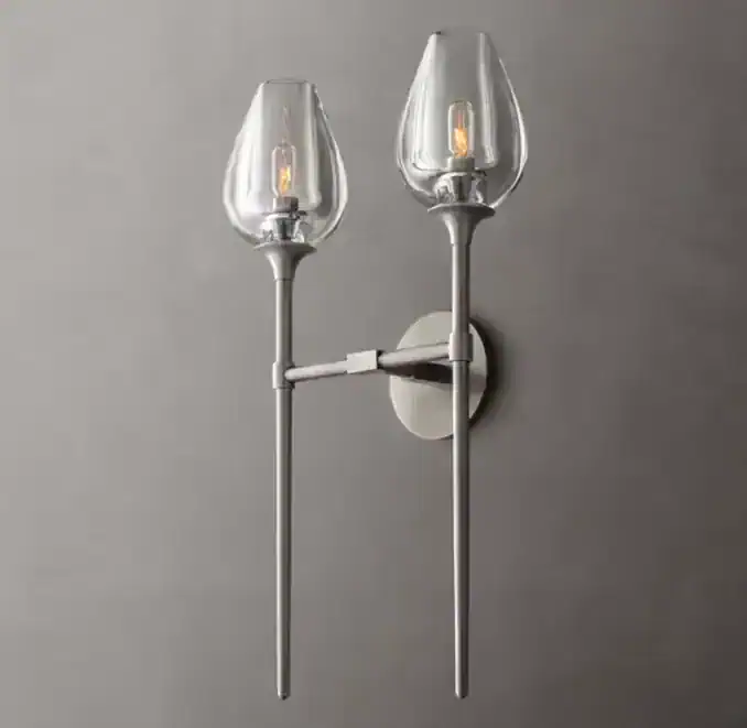 Modern double wall light with tulip-shaped glass shades and brass accents.