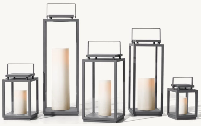 Set of five modern outdoor candle lanterns with LED candles in various sizes.