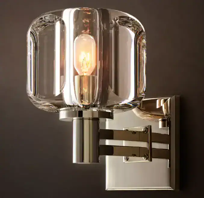 Elegant K9 glass sconce with modern metallic finish for luxury lighting.