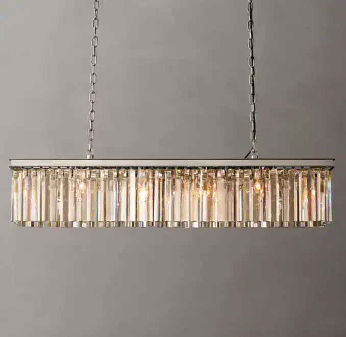 Elegant modern crystal chandelier hanging from ceiling with chains.
