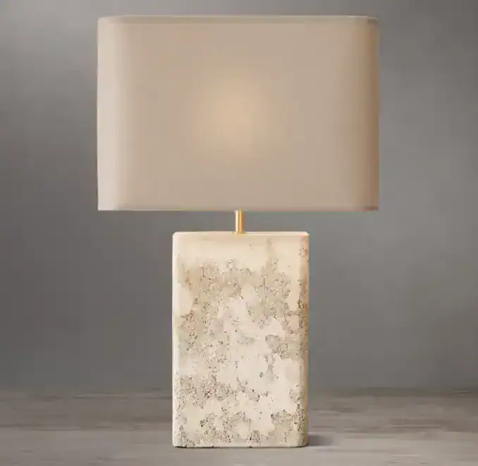 Rectangular travertine table lamp with beige fabric shade for modern decor.