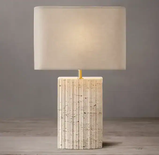 Elegant travertine table lamp with a beige fabric shade for modern decor.
